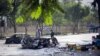Afghan security officials inspect the scene of a bomb blast outside Kabul University in Kabul on July 19.