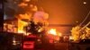 Pompierii lucrează pentru a stinge un incendiu provocat de loviturile rușilor cu drone din regiunea Harkov, de pe 4 mai.