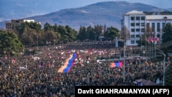 Nagorno-Karabakh - Protesters hold a giant Armenian flag as they attend a rally in Stepanakert, December 25, 2022. 