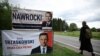 O femeie, trecând pe lângă panouri electorale ale candidaților la alegerile prezidențiale din Polonia, în orașul Pabianice din centrul țării, înainte de turul doi de scrutin, de pe 1 iunie 2025