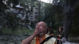 A man reacts to the sight of a destroyed apartment block in Kyiv on the morning of June 17. 