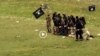 FILE: Grab from a video that shows militants loyal to the Islamic State (IS) blowing up bound and blindfolded Afghan prisoners with explosives. The victims were from Nangarhar Province. IS released the video in August 2015.