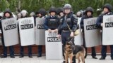 Kazakhstan - Shymkent - mother Laura KalyRiot police officers keep watch on opposition supporters during a rally - Kazakhstan protest in Nur-Sultan on June 9, 2019 - the day of Kazakhstan's presidential elections. (Photo by VYACHESLAV OSELEDKO / AFP)