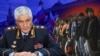 Коллаж: Колокольцев и мигранты