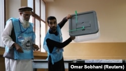 Afghan election commission workers prepare ballot papers for counting after the September 28 voting..
