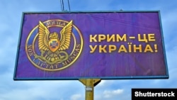 Білборд із емблемою контррозвідки СБУ і написом, що Крим – це Україна, який встановили перед посольством Росії в Україні. Київ, 1 квітня 2021 року